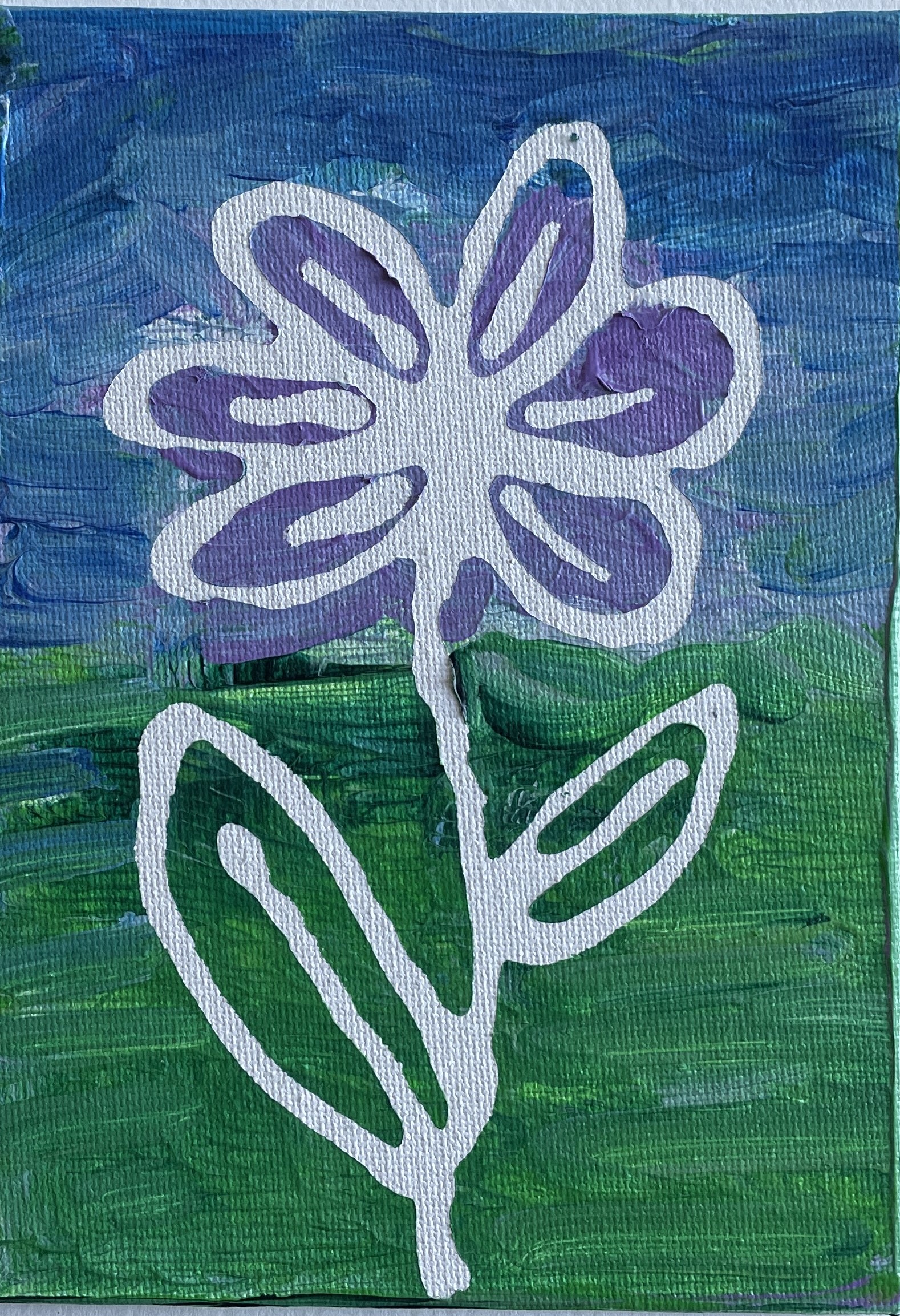 White flower on green and blue background showing negative art technique