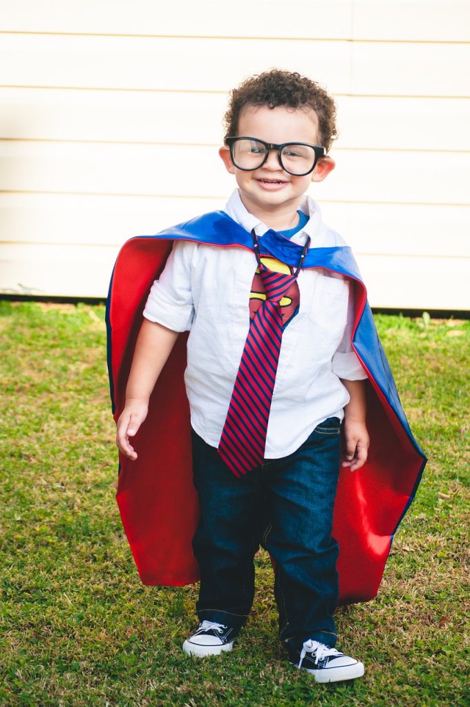 Young child wearing superman costume