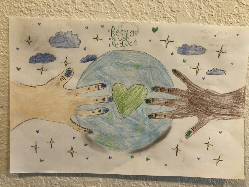 hands hold earth-day poster