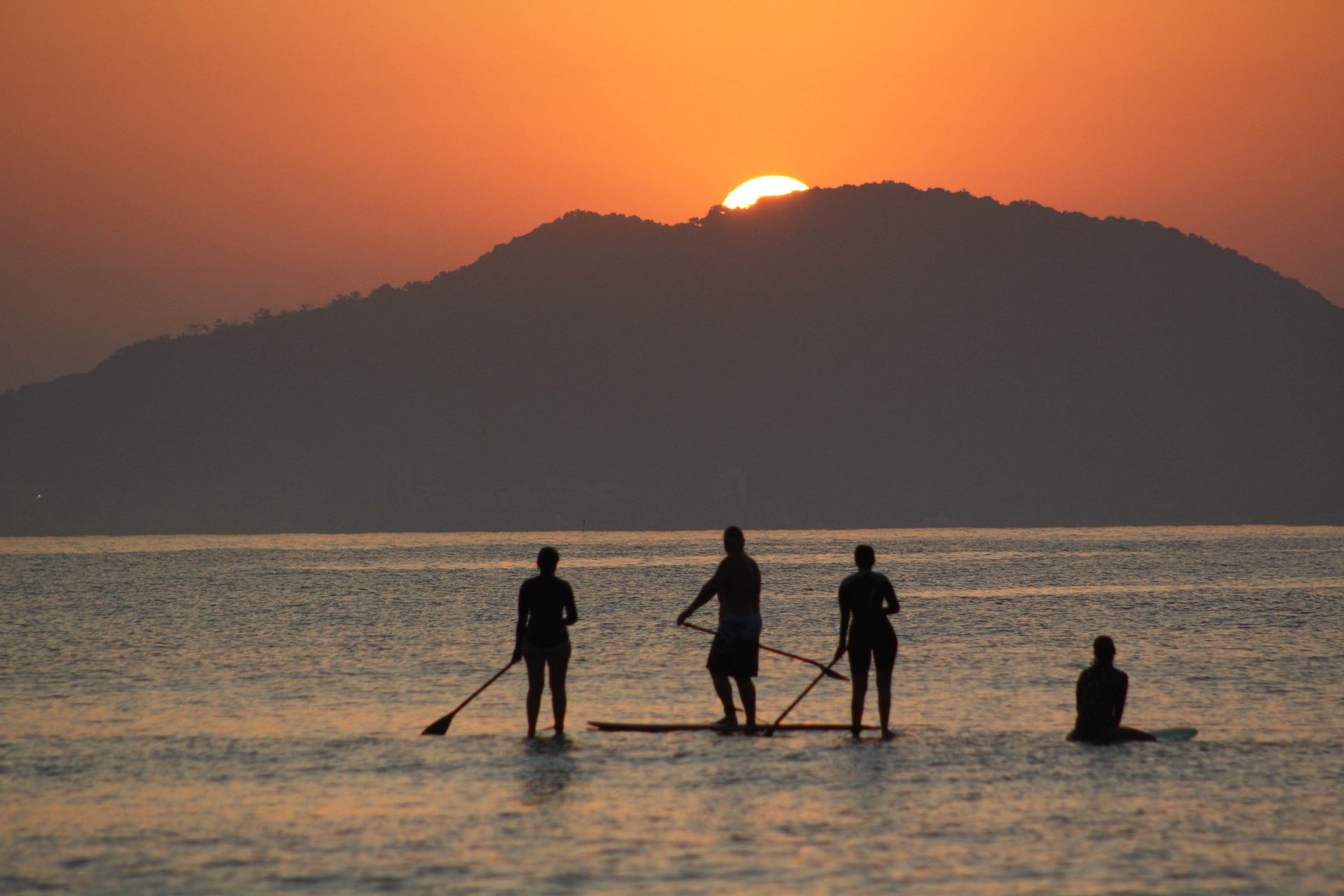 group of people paddleboarding on lake